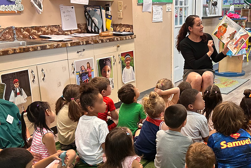 Shawna reading to children in classrom